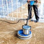 people polishes floor indoors